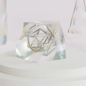 Metallic geometric framework suspended inside a transparent cube on a white platform